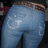 A person wearing light blue denim jeans with a brown belt, viewed from behind showing the back pockets and lower torso.