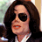 Pixelated image of a person with dark hair and sunglasses on red background, text reads 'Let's Go Get Our Skin Bleached!' in black pixel font.