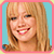 Static pixelated image of a smiling woman with long blonde hair against a light blue background, framed by a pink border.