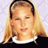 Static 48x48 pixel icon of a person with long blonde hair wearing a black top and white collar, set against a light purple background.