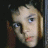 A 48x48 pixel buddy icon split into two sections: a partial face on the left and green text on the right against a dark background.
