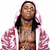 A person with long dark hair wears a pink and white patterned hoodie over a bare chest, standing against a plain background.