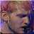 Pixelated close-up of a person's face with light skin tone, dark hair, and closed eyes against a purple and pink gradient background.
