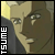 Pixelated close-up of a character's face with light skin tone, dark hair, and a dark jacket, featuring vertical white text on the left side.