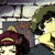 Animated sequence showing two characters in dynamic poses against a stone wall background, one with dark hair and green jacket, the other with long brown hair and yellow top.