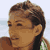 Static pixelated image of a person's head and shoulders with brown hair, light skin tone, and visible facial features against a pale background.