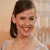 Static 50x50 pixel icon showing a person with dark hair in a side ponytail against a light background, wearing a sleeveless top with visible shoulder straps.