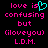Pixelated text in pink and cyan on black background with a heart symbol replacing 'is' in 'love is confusing but (iloveyou) L.D.M.'