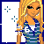 Pixelated image of a blonde woman with long hair wearing a blue and white striped top, standing beside a gray panel with partial text and blue crosses.