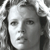 Pixelated grayscale portrait of a person with short hair, neutral expression, and visible facial features including eyes, nose, and mouth against a light background.