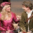 A static image with a pink background, featuring a pixelated scene of two people and pink text reading "If you can hear. How much I want you to stay? Can I just say".