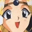 Anime character with large blue eyes, open mouth, and a blue gem on forehead, next to black background with white text.