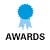 Blue circular badge with light blue ribbon below, positioned above bold black text reading AWARDS on white background.