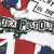 Pixelated static image with red, white, and blue sections; prominent black text reading "U.S. FOOTBALL" in blocky font over a stylized background.