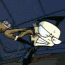 Animated sequence of a cartoon character with brown hair and black boots holding a large white object against a dark blue background.