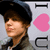 A person wearing a dark cap and gray jacket appears in a of four with a pink heart symbol and partial text on a light background