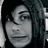 A pixelated grayscale portrait of a person with long hair on the left, next to red pixelated text on a black background.