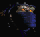 Animated sequence of a blue-clad figure with glowing orange eyes and a metallic helmet, performing a side-to-side motion against a black background.