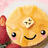 A pixelated cartoon pancake with a smiling face, pink cheeks, and a pat of butter on top, set against a blurred background.