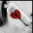 A static pixelated image shows a red heart-shaped object on a white curved surface with dark vertical elements on the left and right edges.