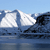 Pixelated image of a white sailboat on blue water under a light blue sky with visible pixelation and no text.