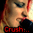 A woman with red hair and blue eyeshadow sings into a black microphone, her mouth open in various frames showing text changes.