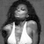 Pixelated grayscale image of a person with long dark hair wearing a white sleeveless top, head tilted back, eyes closed, and mouth slightly open.