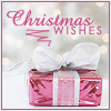 Pink gift box with white ribbon bow, blurred bokeh background, and pink text reading "Christmas WISHES" with decorative swirl.