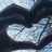 A static image shows a heart-shaped frame made of dark fabric over a light blue patterned background, with four text blocks in pixelated font.