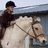 A pixelated image of a person riding a light brown pony with text overlays on dark red and gray backgrounds.