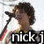 Pixelated image of a person with curly brown hair singing into a microphone, overlaid with text and heart symbols.