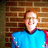 Pixelated image of a person in a blue shirt against a brick wall, with text labels 'band.' and 'nerd.' on black and gray backgrounds.