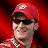 A red and white animated icon featuring a person in racing gear with a race car, showing sequential motion of the head turning left to right.