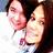 Two pixelated faces in close proximity, one with dark hair and the other with lighter brown hair, both wearing white tops against a light background.
