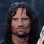 Pixelated close-up of a person with long dark hair against a dark blue background, showing facial features and neck.