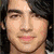 A pixelated image of a person with long dark hair and a light-colored shirt, next to a blue with text and symbols