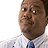 A static image of a man in a striped shirt and blue tie with multiple 'guess who' text overlays.