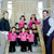 Group of people in formal attire with pink accents and bold text overlay reading 'Jon and Kate Plus 8!' on a light background.
