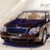 A dark blue sedan with visible headlights and side mirrors appears in a low-resolution static image against a light background.