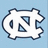 Pixelated white icon with irregular border on light blue background, containing two dark blue triangles and one vertical oval shape.