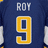 A pixelated close-up of a dark blue sports jersey with white text "ROY" above a large yellow number 9 outlined in light gray.