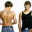 Two side-by-side images of a man with short brown hair, one showing his back and the other his front, accompanied by green pixelated text on black background.