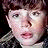A pixelated image of a person's face next to the text "goonies never say die" on a black background, presented as part of an animated contact sheet with two frames.
