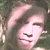 A pixelated image of a person with light brown hair and fair skin, next to green text reading 'Original Icons .com' on a dark background.
