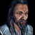 Pixelated static image of a person with long dark hair, light skin, and a beard, wearing a light blue shirt against a black background.