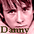 nine identical pixelated faces with the name "Danny" repeated in various colors , forming a static pattern