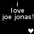 Pixelated text 'i love joe jonas! joe jonas!' repeated twice on black background with two heart symbols, one white and one gray.