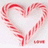 A heart-shaped candy cane outline on white background with 'love' text, next to green with red 'happy holidays' text