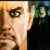 Pixelated close-up of a person's face with light skin, brown hair, and dark eyes against a blurred background.
