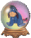 Crystal ball with pink and yellow gradient background contains blue cartoon character on brown wooden base.